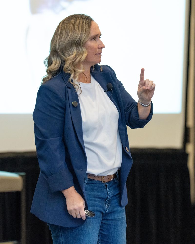 Natty Lewis speaking on stage