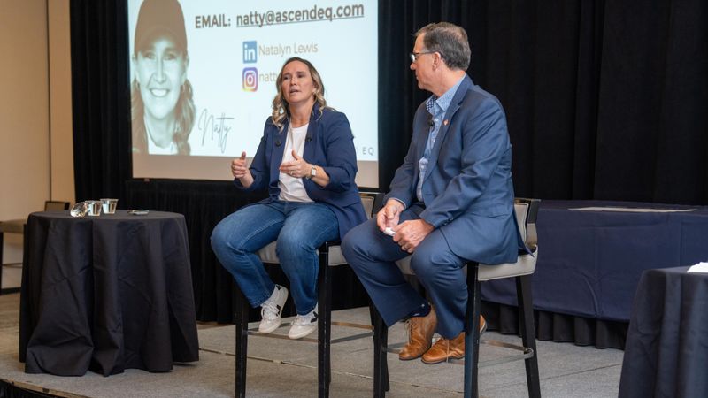 Natty Lewis speaking with someone